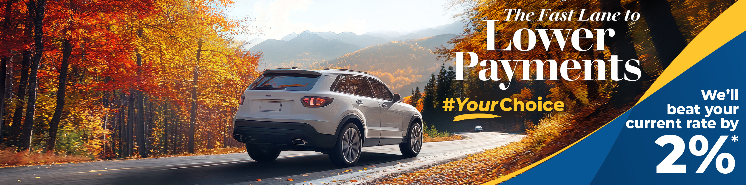 Grey SUV driving down a winding road during the fall season.